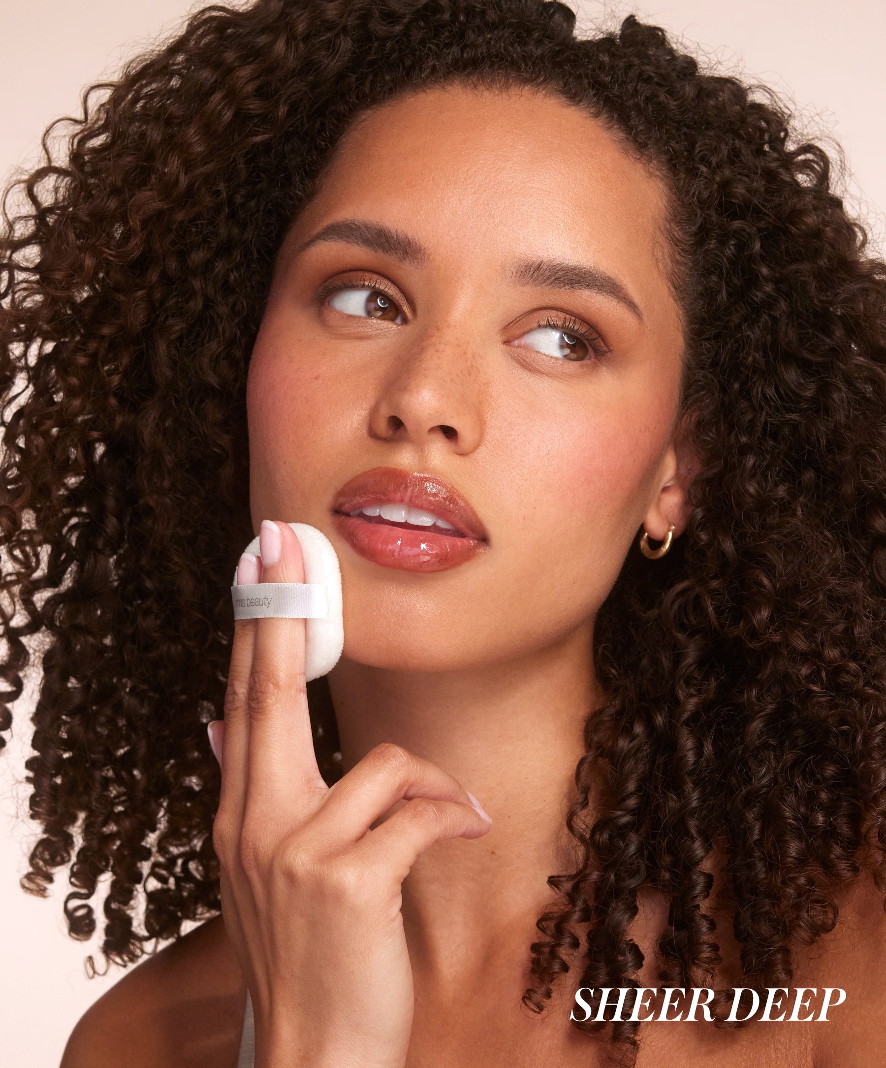 Close-up of model wearing RMS Hydra Setting Powder in shade Deep